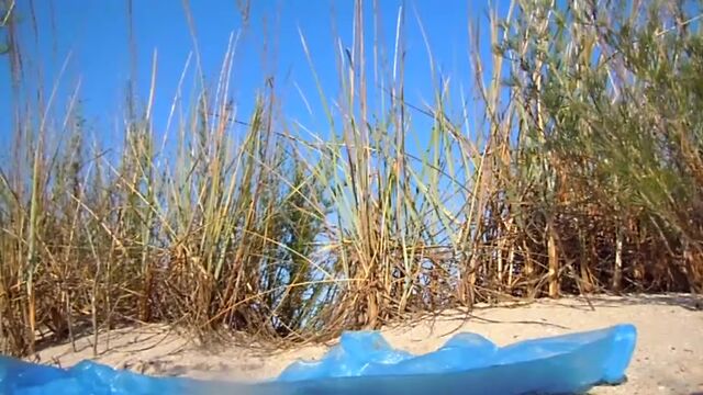 Russian girl poops in the sand dunes